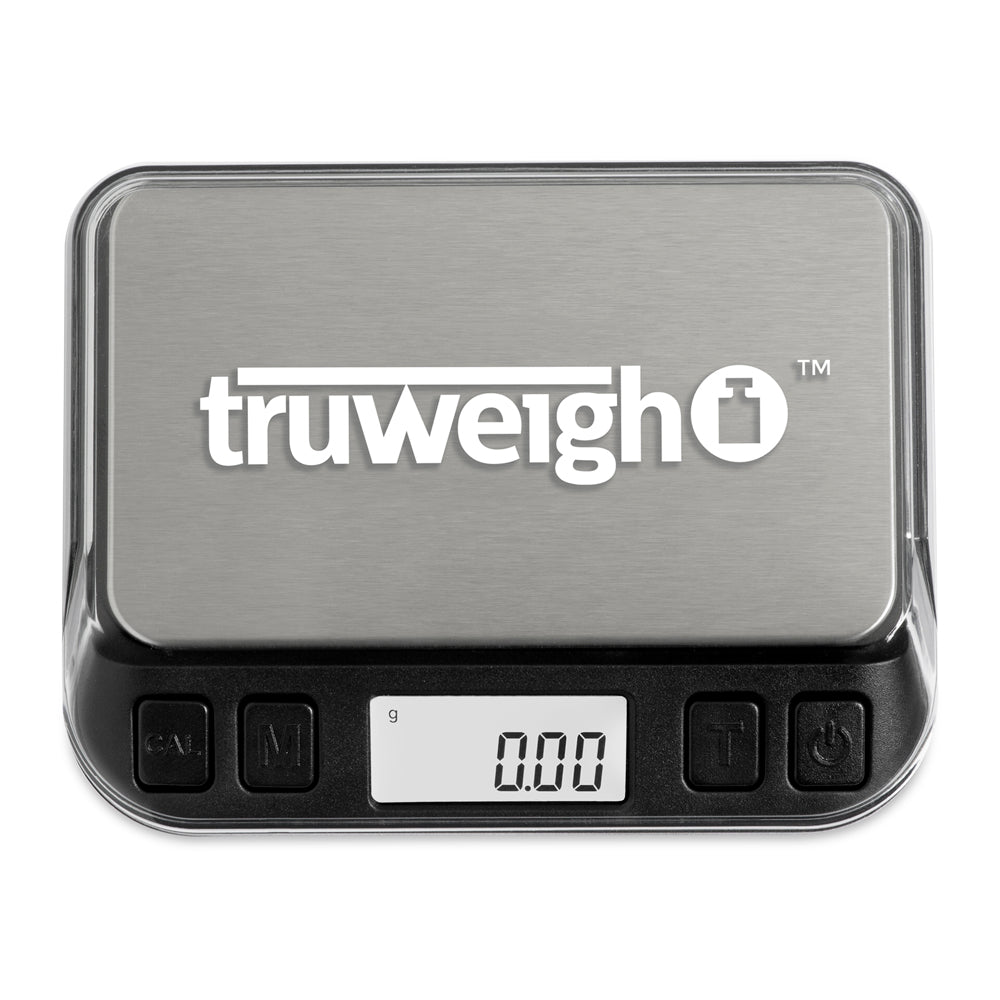 The Truweigh Zenith digital mini scale is turned on with the clear cover on the scale