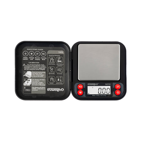 The black Truweigh Note pocket scale is shown turned on with the cover completely open